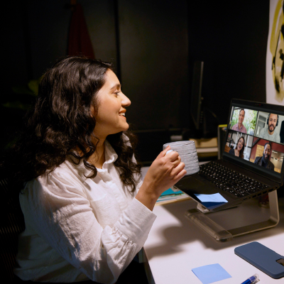 Woman video chatting with coworkers. 